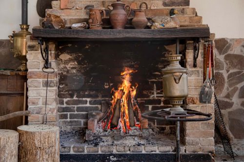 Fireplace with a burning fire, comfort and atmosphere.